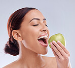 Apple, bite or happy woman in studio eating on white background for healthy nutrition or clean diet. Smile or hungry beautiful girl advertising or marketing natural organic green fruits for wellness