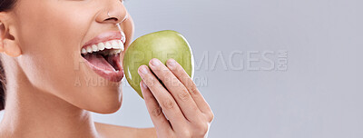 Buy stock photo Mockup, apple bite or woman eating in studio on white background for healthy nutrition or clean diet. Closeup, space on banner or open mouth of hungry girl marketing natural green fruit for wellness