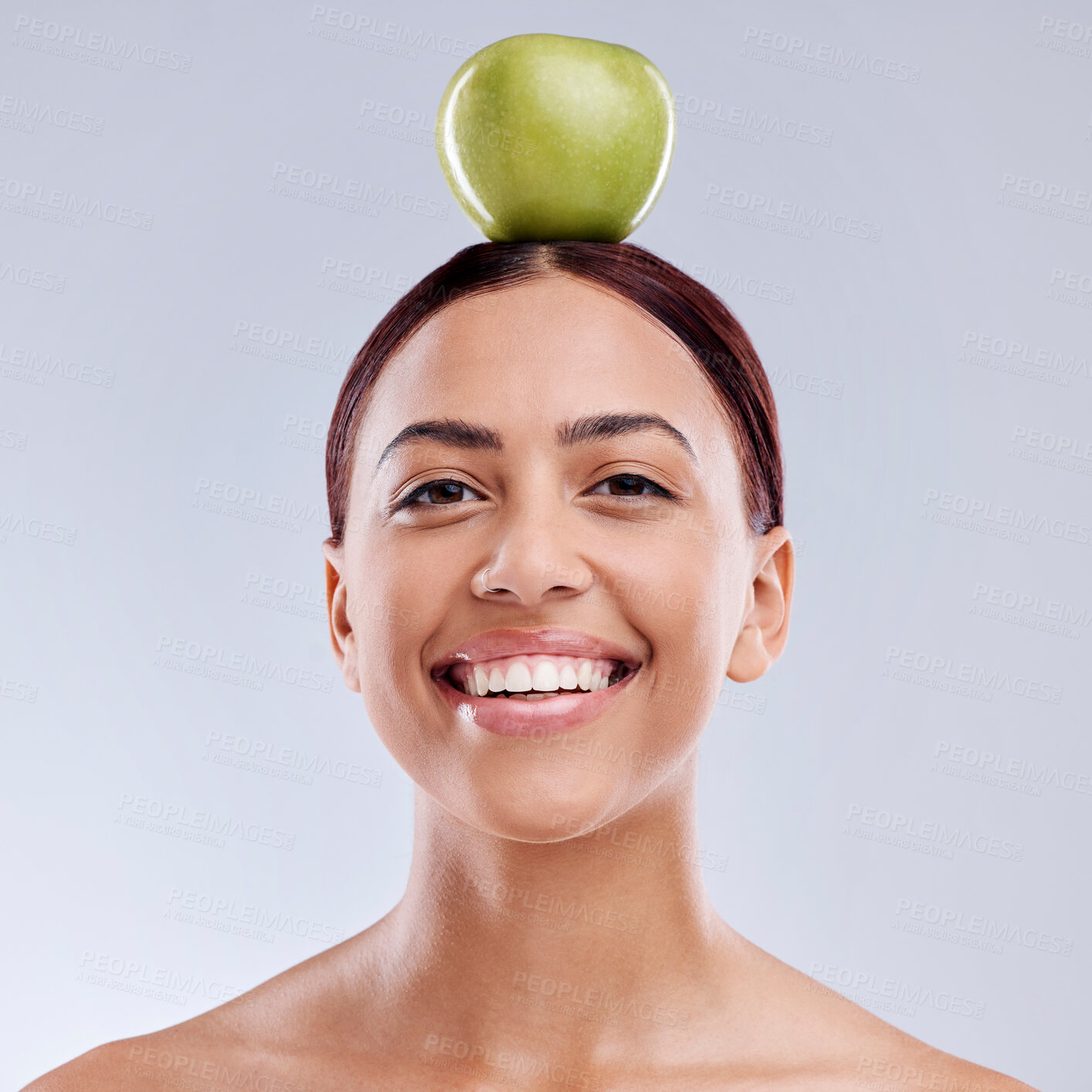 Buy stock photo Apple, balance or portrait of happy woman in studio on white background for healthy nutrition or clean diet. Smile, face or beautiful girl with natural organic fruit on head for wellness benefits