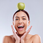 Apple, balance or portrait of excited woman in studio on white background for healthy nutrition or clean diet. Smile, wow or happy girl advertising or marketing a natural green fruit for wellness