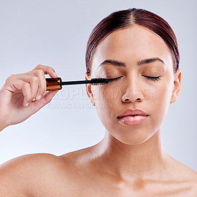 Buy stock photo Beauty, face and woman with mascara makeup, cosmetics and product brush on eye, lashes and studio background. Cosmetic, closed eyes and model with eyelashes tool for make up, skincare and self care