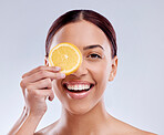 Skincare, portrait or happy girl with orange or natural facial with citrus or vitamin c on studio background. Wellness, smile or healthy woman smiling with organic fruits for dermatology beauty 