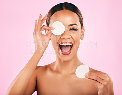 Buy stock photo Happy woman, face and cotton pad in skincare, makeup removal or cosmetics against a pink studio background. Portrait of excited female person with cosmetic swab in beauty cleaning or facial treatment