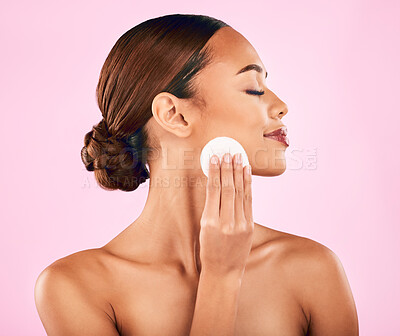 Buy stock photo Woman, face and cotton pad in skincare for makeup removal or cosmetics against a pink studio background. Female person or model in relax with cosmetic swab for beauty, cleaning or facial treatment