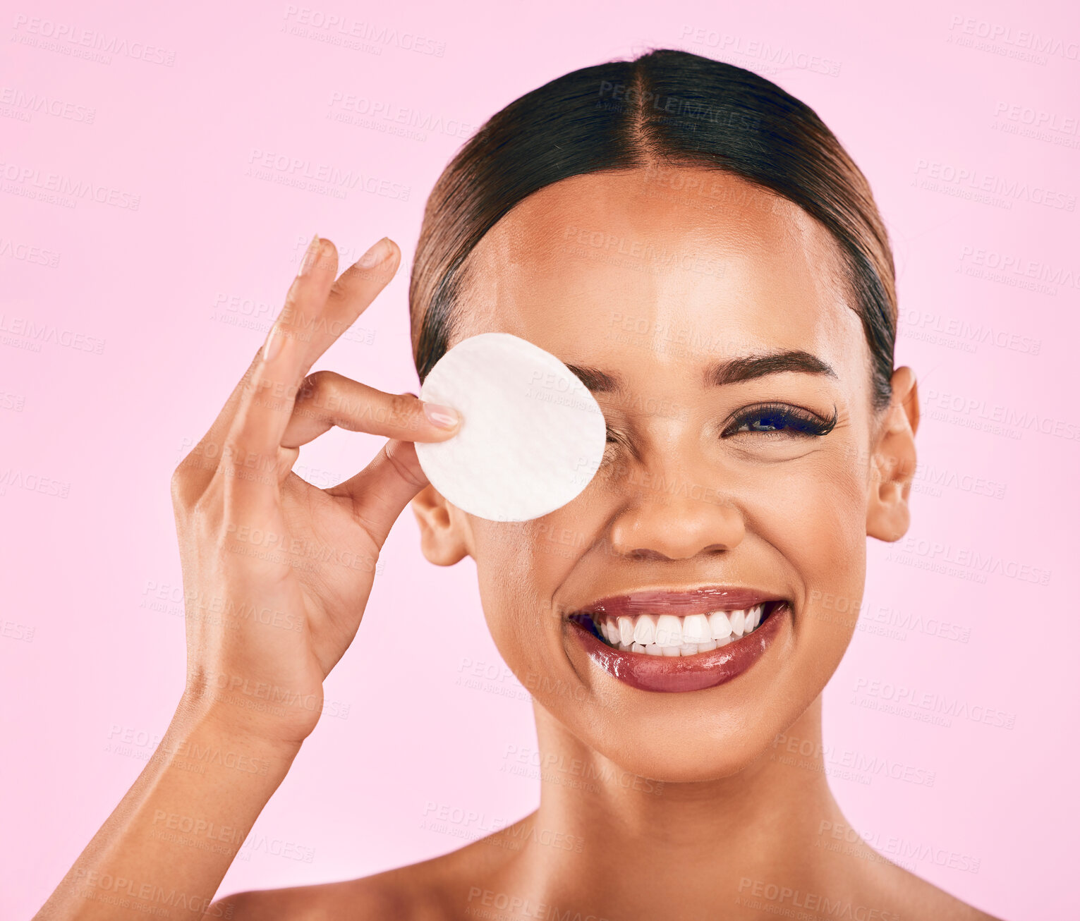 Buy stock photo Happy woman, face and cotton pad in makeup removal, skincare or cosmetics against a pink studio background. Portrait of excited female person with cosmetic swab in beauty cleaning or facial treatment