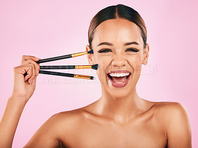 Buy stock photo Happy woman, portrait and makeup brushes for beauty cosmetics against a pink studio background. Excited female person with cosmetic tools or equipment for grooming, skin products or facial treatment