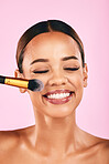 Happy woman, face and makeup brush for beauty cosmetics against a pink studio background. Female person, smile and brushing with cosmetic tool or equipment for grooming, applying or facial treatment