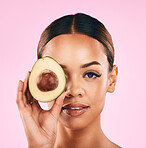 Woman, portrait and avocado for natural skincare, beauty or cosmetics against a pink studio background. Female person or model with fruit or vegetable in healthy nutrition, fiber or diet for wellness