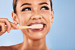 Face, woman and bamboo toothbrush for cleaning, toothpaste and dental health on studio background. Teeth, clean and wash mouth with eco friendly brush for hygiene, self care and healthy tooth