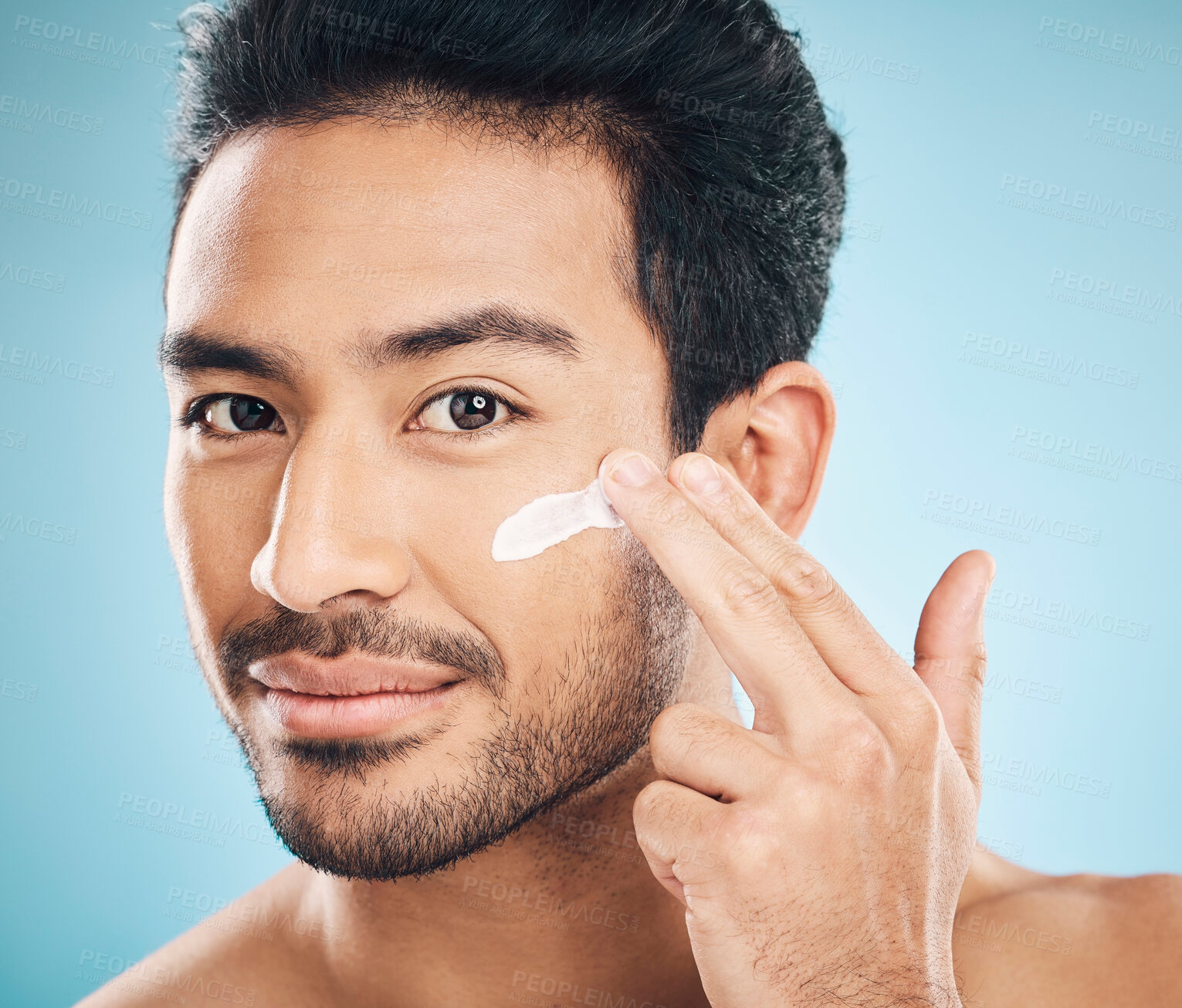 Buy stock photo Skincare, portrait and man with facial cream in studio for natural, wellness and health routine. Cosmetic, face and male model with spf, lotion or creme for dermatology treatment by a blue background