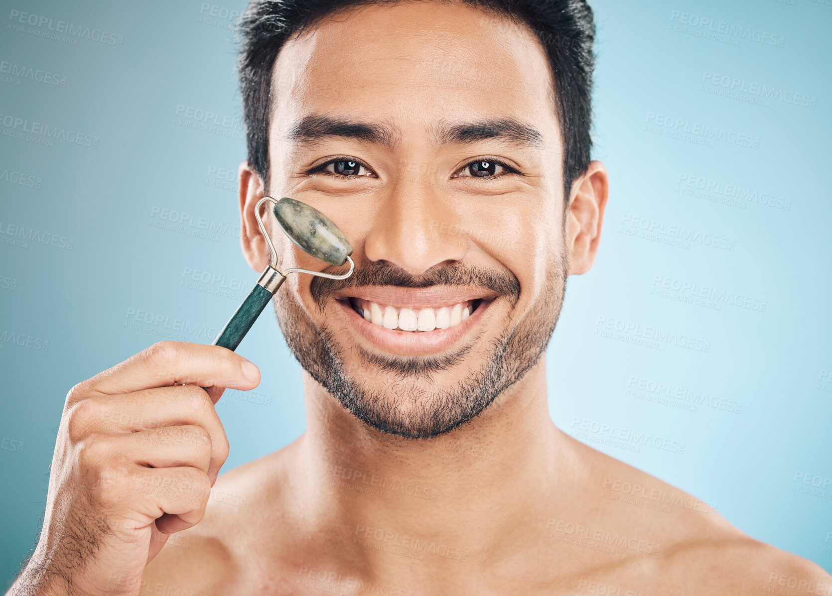 Buy stock photo Beauty, portrait or happy man with jade roller, facial product for soft or healthy skincare on studio background. Relaxing, grooming or male model smiling with dermatology cosmetics for face massage