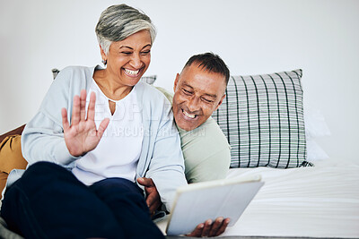 Buy stock photo Digital tablet, video call and senior couple speaking, waving and bonding on a sofa in their house. Happy, smile and elderly man and woman in retirement on a virtual conversation with mobile at home.