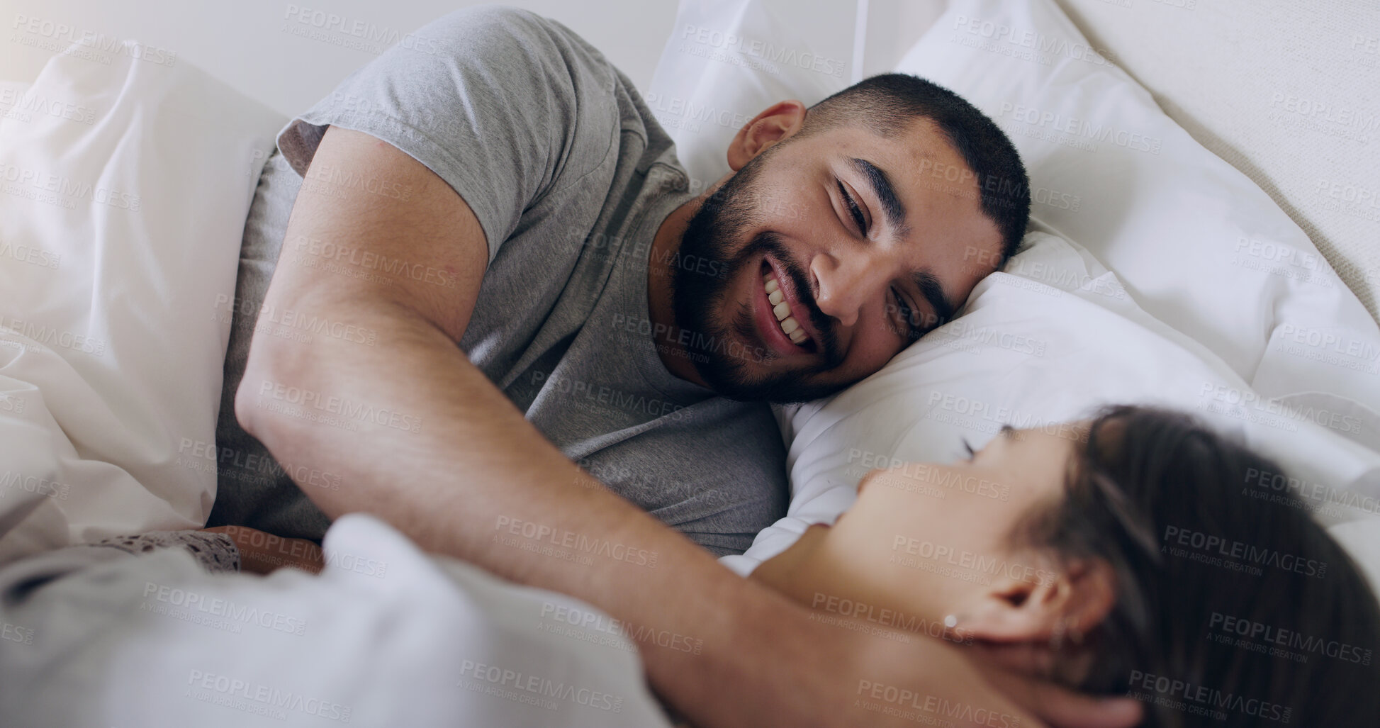 Buy stock photo Face, happy man and relax with woman in bed, room and enjoy romance of quality time together at home. Couple, relationship and bonding in morning for love, care and happiness for partner on honeymoon
