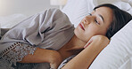 Woman, tired and thinking in bed, home or relax on holiday with vision, memory or ideas in morning. Girl, bedroom and remember with anxiety, mindfulness or fear at hotel, house or vacation in Mexico