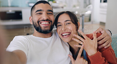Buy stock photo Couple, selfie and engagement ring in living room portrait for happiness, romance and love on social media app. Man, woman and excited for marriage proposal, offer and celebration with smile on blog