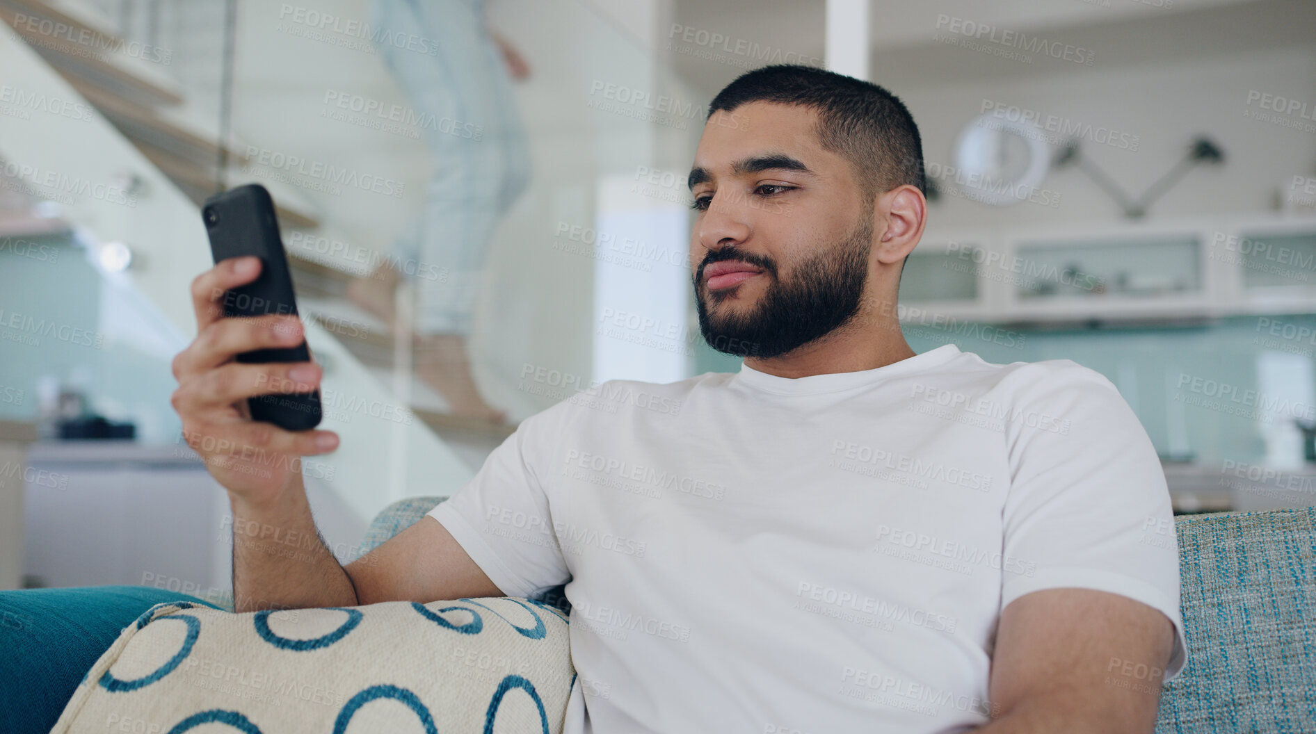Buy stock photo Man, cellphone and typing on sofa in living room, reading social media post and online blog. Young male person, relax and texting on smartphone, download mobile games and website connection at home