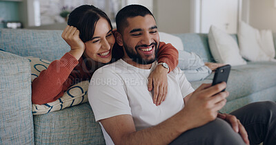 Buy stock photo Couple, phone and laughing at meme on social media or internet joke and relax in a living room couch in a home. Sofa, cellphone and people streaming online comedy on a smartphone in a house together
