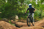 Mountain bike, man and motion blur in forest for adventure, speed and power. Athlete, sports and bicycle for outdoor action, off road competition and cardio fitness for adrenaline, freedom and trail