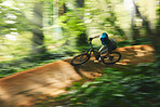 Mountain bike, motion blur and cycling in forest for adventure, speed and power from above. Athlete, fast sports and bicycle for outdoor action, cardio and path park for adrenaline, freedom and trail