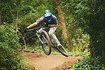 Mountain bike, man and jump in park for extreme sports, cycling competition and adventure of action, challenge or courage. Bicycle, athlete and stunt in air for skill, adrenaline and freedom of racer