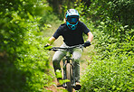 Mountain bike, man and cycling in forest for competition, freedom and off road adventure on path. Athlete, extreme sports and bicycle for action, cardio race and adrenaline in nature, park and trail