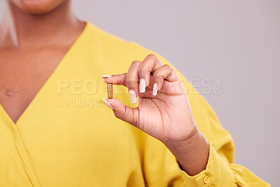 Buy stock photo Pharmaceutical, hand and woman with a pill in a studio for healthcare, wellness or recovery medication. Medical, medicine and closeup of female person with tablet capsule isolated by gray background.