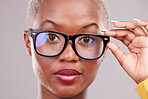 Black woman, face and glasses with vision in portrait, 
prescription lens and frame isolated on studio background. Female person eyewear, optometry and health insurance with confidence and eye care