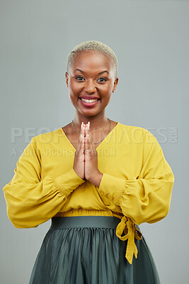 Buy stock photo Gratitude, praying hands and portrait of happy woman in studio with thank you sign on wall background. Face, together hand and smile by female person showing gratitude, prayer and worship emoji icon