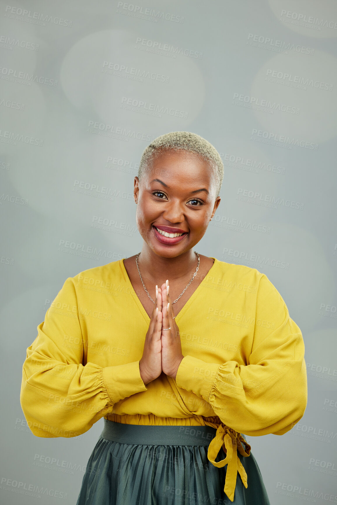 Buy stock photo Praying hands, thank you and portrait of happy woman in studio with gratitude sign on wall background. Face, together hand and smile by female person showing space, prayer and worship emoji icon