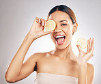 Woman, lemon and studio portrait for skin health, wellness and facial glow by white background. Girl, model and healthy skincare with youth, makeup and cosmetics for self care, funny face and excited