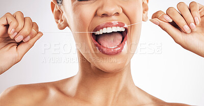 Buy stock photo Smile, dental and woman flossing teeth in studio for hygiene, wellness or fresh breath on grey background. Hands, floss and lady relax with mouth, tooth or cleaning for oral care or cavity prevention