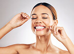 Smile, oral care and woman flossing teeth in studio for hygiene, wellness or fresh breath on grey background. Face, floss and lady relax with mouth, tooth or cleaning for dental or cavity prevention