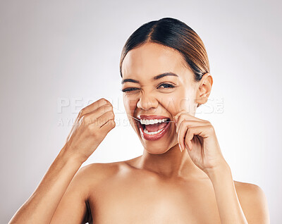 Buy stock photo Dental, portrait and happy woman flossing teeth in studio for hygiene, wellness and fresh breath on grey background. Face, floss and female relax with mouth, tooth and cleaning for oral care routine 