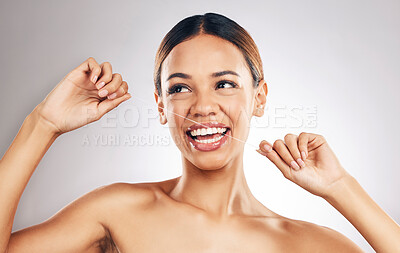 Buy stock photo Smile, dental floss and woman in studio for mouth, teeth and wellness, hygiene or fresh breath on grey background. Flossing, happy and girl model cleaning gum, tooth and bacteria or cavity prevention