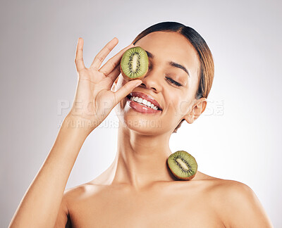 Buy stock photo Kiwi, skincare and happy woman in studio for beauty, wellness or self love with natural cosmetic on grey background. Organic, treatment and female model with fruit for hyperpigmentation prevention