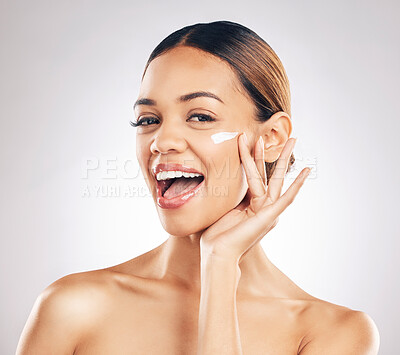 Buy stock photo Happy woman, cream on face and beauty with skincare, smile and moisturizer isolated on studio background. Excited female model apply lotion, dermatology and cosmetic product with skin glow and facial