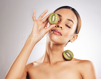 Buy stock photo Skincare, kiwi and woman in studio for wellness, beauty or body care with natural cosmetic on grey background. Organic, treatment and female with fruit for vegan, eco or antioxidant, luxury or facial