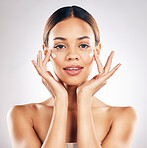 Skincare, portrait and face cream for woman in studio with healthy, glowing or anti aging beauty on grey background. Facial, hands and female model relax with dermatology, sunscreen and lotion