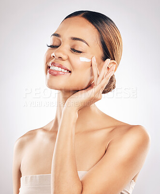 Buy stock photo Woman with smile, cream on face and beauty, skincare and moisturizer isolated on studio background. Happy female model apply lotion, dermatology and cosmetic product with skin glow and facial