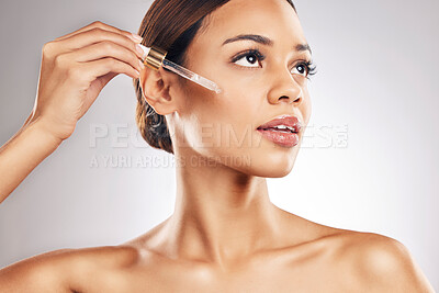 Buy stock photo Woman, face and oil for skincare with beauty, cosmetic serum product isolated on studio background. Natural cosmetics, female model with pipette and hyaluronic acid for skin glow with dermatology