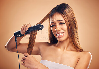 Buy stock photo Woman with flat iron, haircare and heat damage, mistake and worried about hair loss on studio background. Electric straightener, female model with anxiety about keratin treatment fail and hairstyle