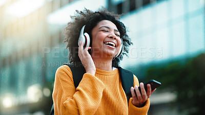 Headphones, phone and black woman in city dancing to music in outdoor lens flare for student lifestyle and wellness. Urban, gen z person dance and listening to audio tech on mobile app, 5g smartphone