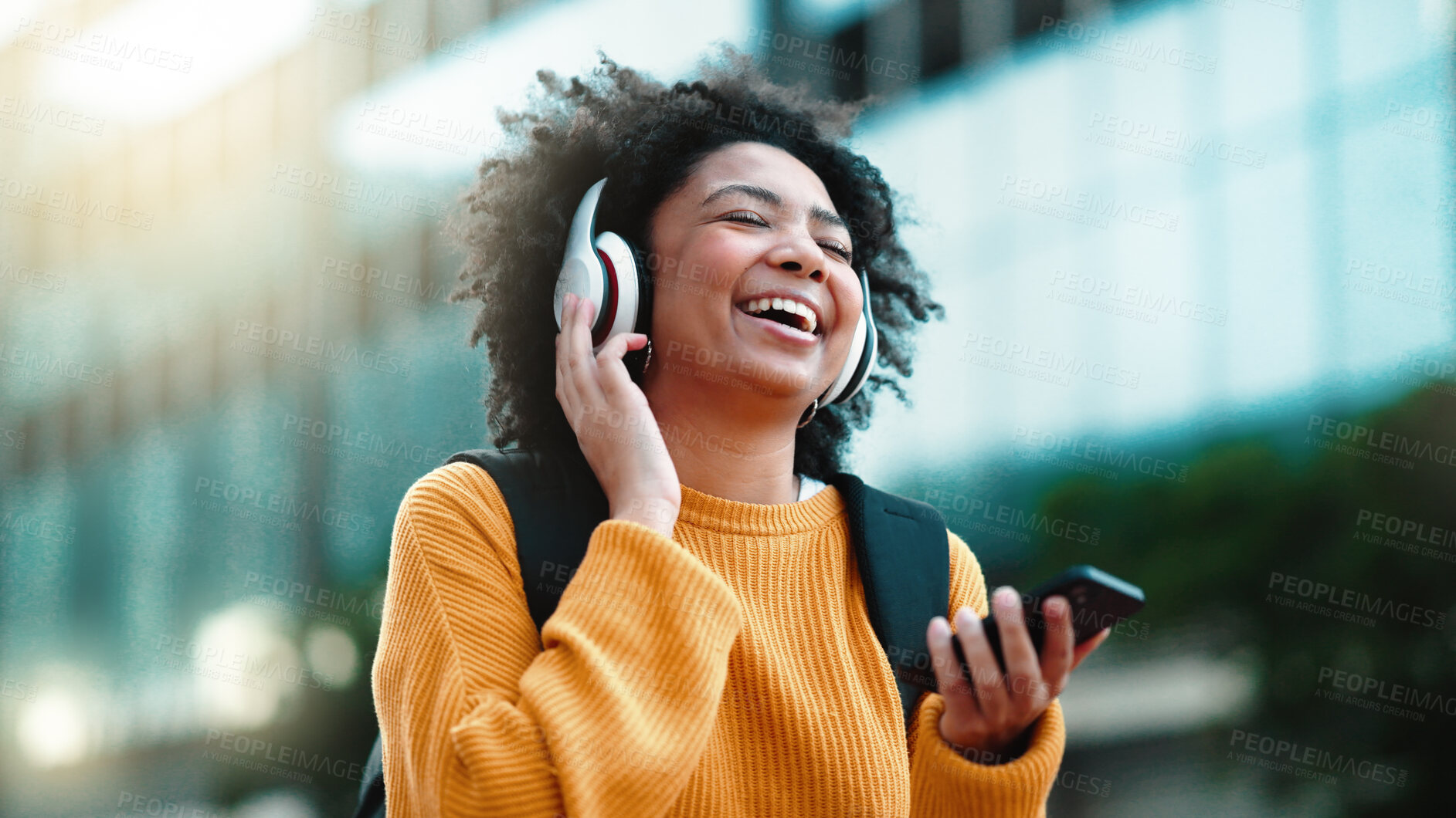 Buy stock photo Happiness, phone music and city woman laughing, listening and streaming radio sound, hip hop or rap song. Headphones, media phone app and outdoor person happy, freedom or on morning wellness walk