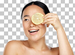 A Portrait, happy and woman using lemon for facial skincare cleaning, vitamin c and cosmetic benefits in studio in Tokyo. Smile, fruit and young Asian beauty model cleaning a glowing face for wellness isolated on a png background