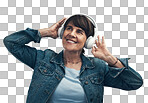 PNG studio shot of a senior woman wearing headphones against a grey background