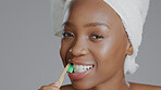 Face, black woman and toothbrush for dental hygiene, smile and girl against a grey studio background. Portrait, African American female and lady with oral health, cleaning mouth and fresh breath.