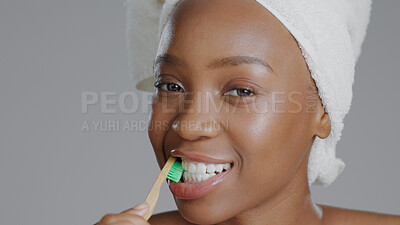 Buy stock photo Face, black woman and toothbrush for dental hygiene, smile and girl against a grey studio background. Portrait, African American female and lady with oral health, cleaning mouth and fresh breath.