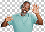 Happy mature african man dancing while listening to music with headphones against isolated on a png background. Carefree senior black man with grey beard celebrating to and enjoying his favourite songs