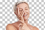One happy mature caucasian woman relaxing with a hand on her face against a pink background. Smiling senior woman resting, caring for her skin while doing a skincare routine