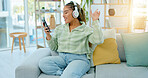 Woman with phone, headphones and dancing while listening to music on work break and relax in office social space. Singing along to radio, online streaming and wifi with energy, fun and rhythm